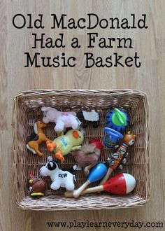 an old mcdonald had a farm music basket filled with toy farm animals and other toys