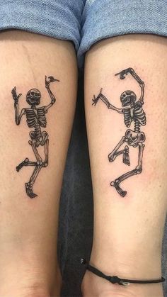 two people with tattoos on their legs that look like they have skeletons tattooed on them