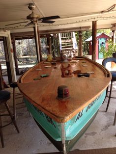 a boat is sitting in the middle of a room with chairs and tables around it