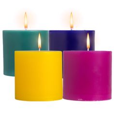 three different colored candles sitting next to each other