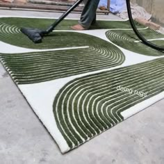 a man is using a vacuum to clean the carpet