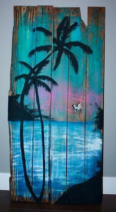 a piece of wood that has been painted with palm trees and the ocean on it