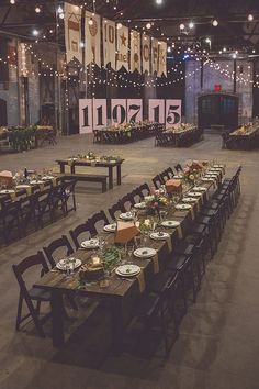 a long table set up with plates and place settings