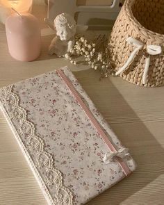 an old book is sitting on a table next to a candle and some other items