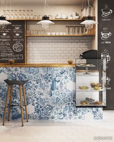 a coffee shop with blue and white tiles on the wall, counter top and stools