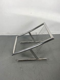 a metal chair sitting on top of a cement floor