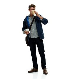 a man standing and drinking from a cup