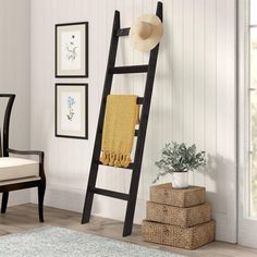 a ladder leaning up against a wall in a room with white walls and wood floors