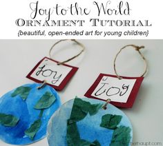 two paper plates with green leaves and the words joy are hanging from twine strings