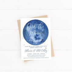 a blue and white card with the words over the moon on it