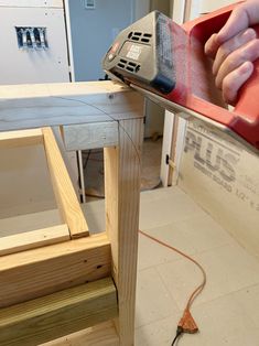 a person using a power tool on a piece of wood