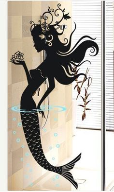 a woman with long hair standing in front of a mirror holding a flower and fish