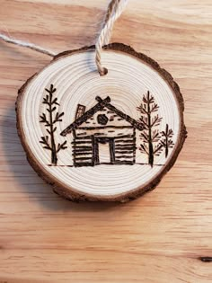 a wooden ornament with a house on it