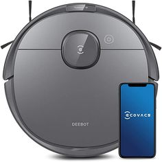 the roomba is next to an iphone