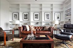 a living room filled with furniture and lots of bookshelves on top of it