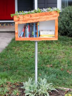 a bookshelf made out of an old bookcase is sitting in the grass