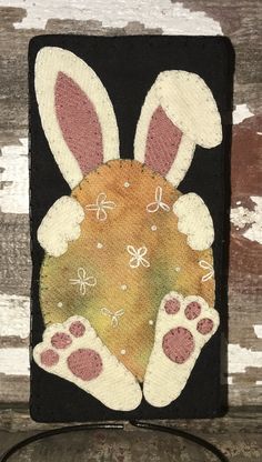 an embroidered bunny's head on a black background