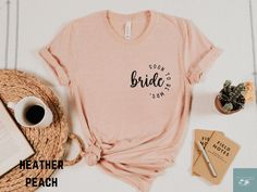 a t - shirt with the words bridal on it next to a cup of coffee