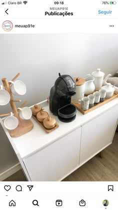 an appliance with plates and cups on the counter in front of a coffee maker