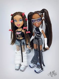 two dolls are standing next to each other