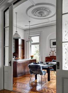 an open door with the words space saving doors on it in front of a dining room table