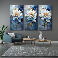 three paintings in a living room with blue and white flowers on the wall above them