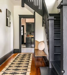 an entry way with stairs and a rug on the floor