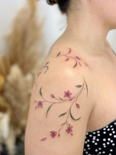 a woman with a flower tattoo on her shoulder