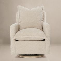 a white chair with a pillow on top of it