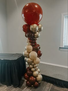 a tall balloon column in the middle of a room