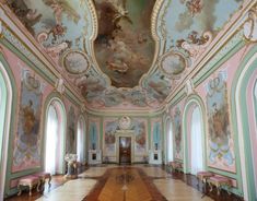 an ornately decorated room with paintings on the walls and ceiling, painted in pastel colors