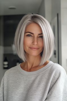 a woman with grey hair is smiling at the camera