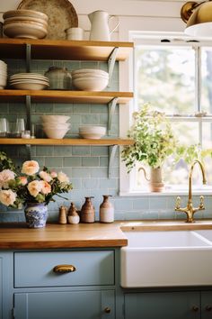 a kitchen filled with lots of counter top space next to a white sink and window