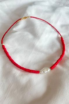 Basic Description: Handmade assorted red fimo beaded necklace. Very dainty. Necklaces are joined with a lobster-style clasp and two inch extended chain.  Sizing:  Each necklace is made with a two inch extender chain so the size can be adjusted to your liking. For example, the 16 inch necklace can be extended up to 18 inches. Care: While necklaces will not be damaged by moisture, avoid getting your necklace wet to prevent potential fading or tarnishing. Red Dainty Necklace With Colorful Beads, Dainty Red Necklace With Colorful Beads, Red Single Strand Jewelry For The Beach, Red Beaded Dainty Jewelry, Dainty Red Beaded Necklaces With Round Beads, Adjustable Red Necklace With Colorful Beads, Dainty Red Necklace With Lobster Clasp, Dainty Red Beaded Necklace With Round Beads, Red Adjustable Dainty Necklace