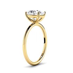 a yellow gold engagement ring with an oval cut diamond in the center and side stones