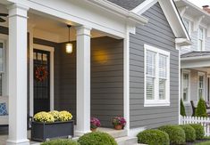 a row of houses with front porches and landscaping