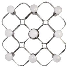 a metal fence with white balls on it