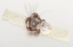 the headband is decorated with flowers and pearls on it's side, along with lace