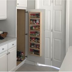 the pantry door is open to reveal spices and condiments