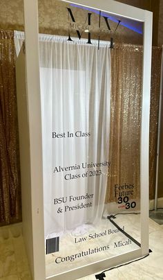 a mirror with the words best in class on it and an image of curtains behind it