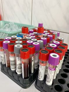 there are many tubes with different colors on the top of each tube and one is filled with blood