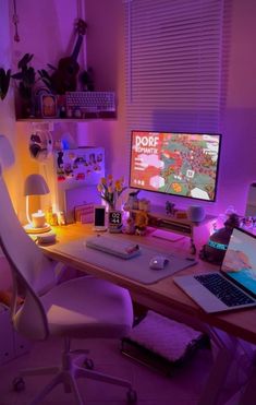 a laptop computer sitting on top of a wooden desk