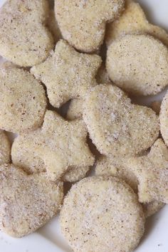 a white plate topped with cookies covered in powdered sugar