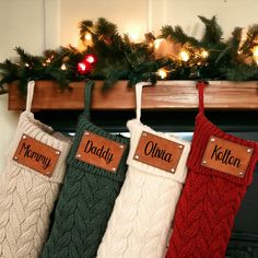 three stockings hanging from a mantel decorated with christmas lights and personalized name tags