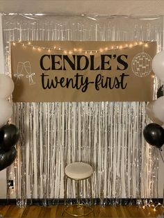 a sign that says candle's twenty - first with balloons and streamers around it