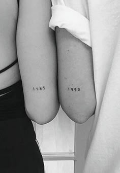 two people with matching tattoos on their arms