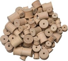 a pile of wooden spools on a white background