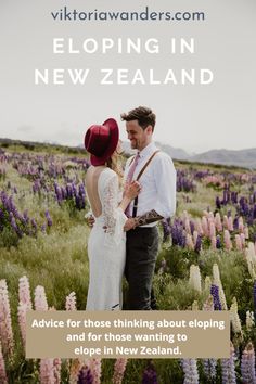 a man and woman standing next to each other in a field with wildflowers