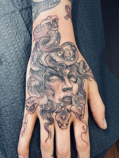 a woman's hand with a tattoo on it