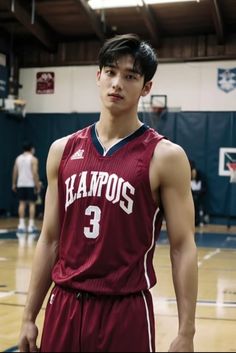 a young man standing on top of a basketball court wearing a red and white uniform